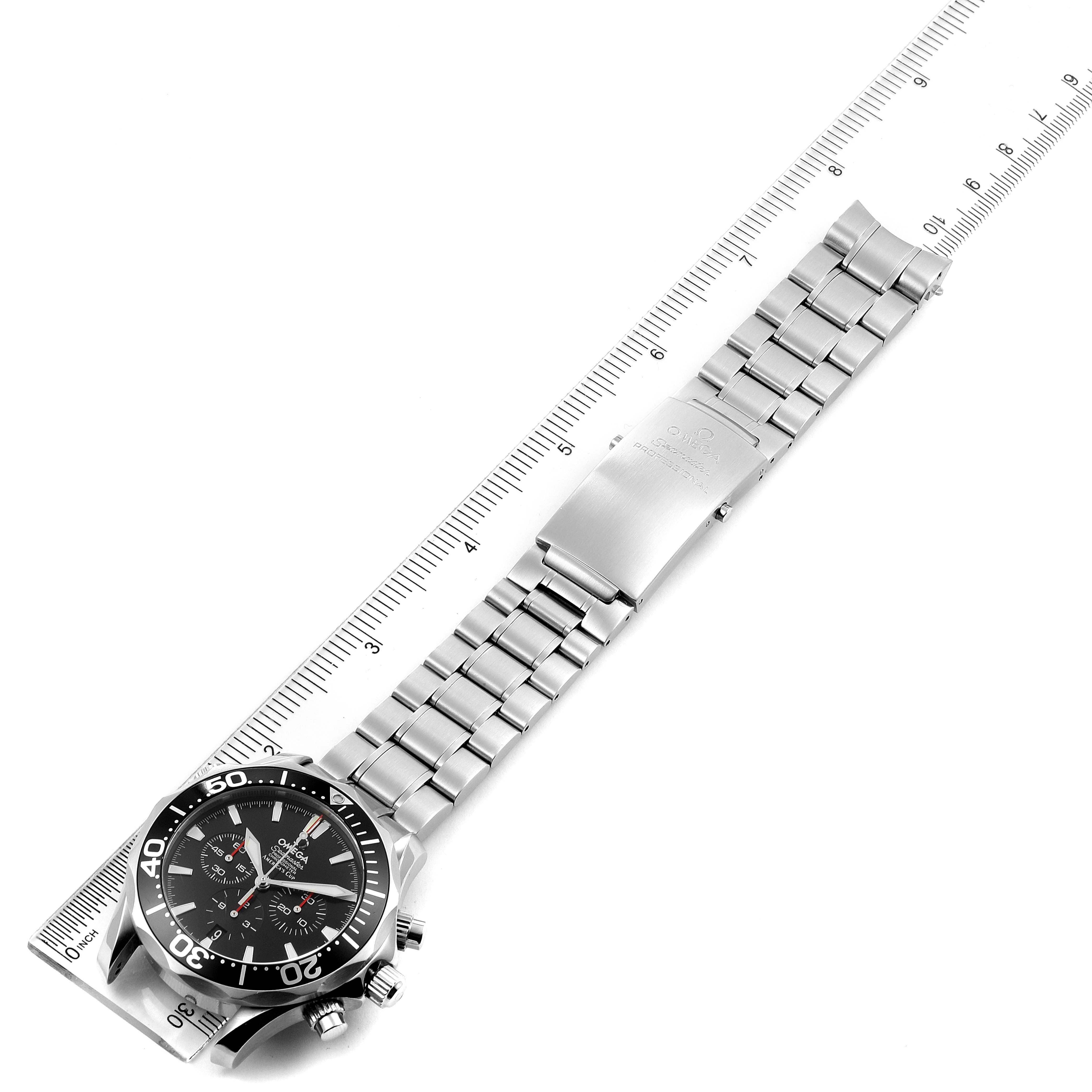 The image shows an Omega Seamaster 2594.50.00 Men
s Stainless Steel Black Dial 2594.50.00 Men
s Stainless Steel Black Dial watch laid flat with the dial and bracelet visible, next to a ruler for scale.