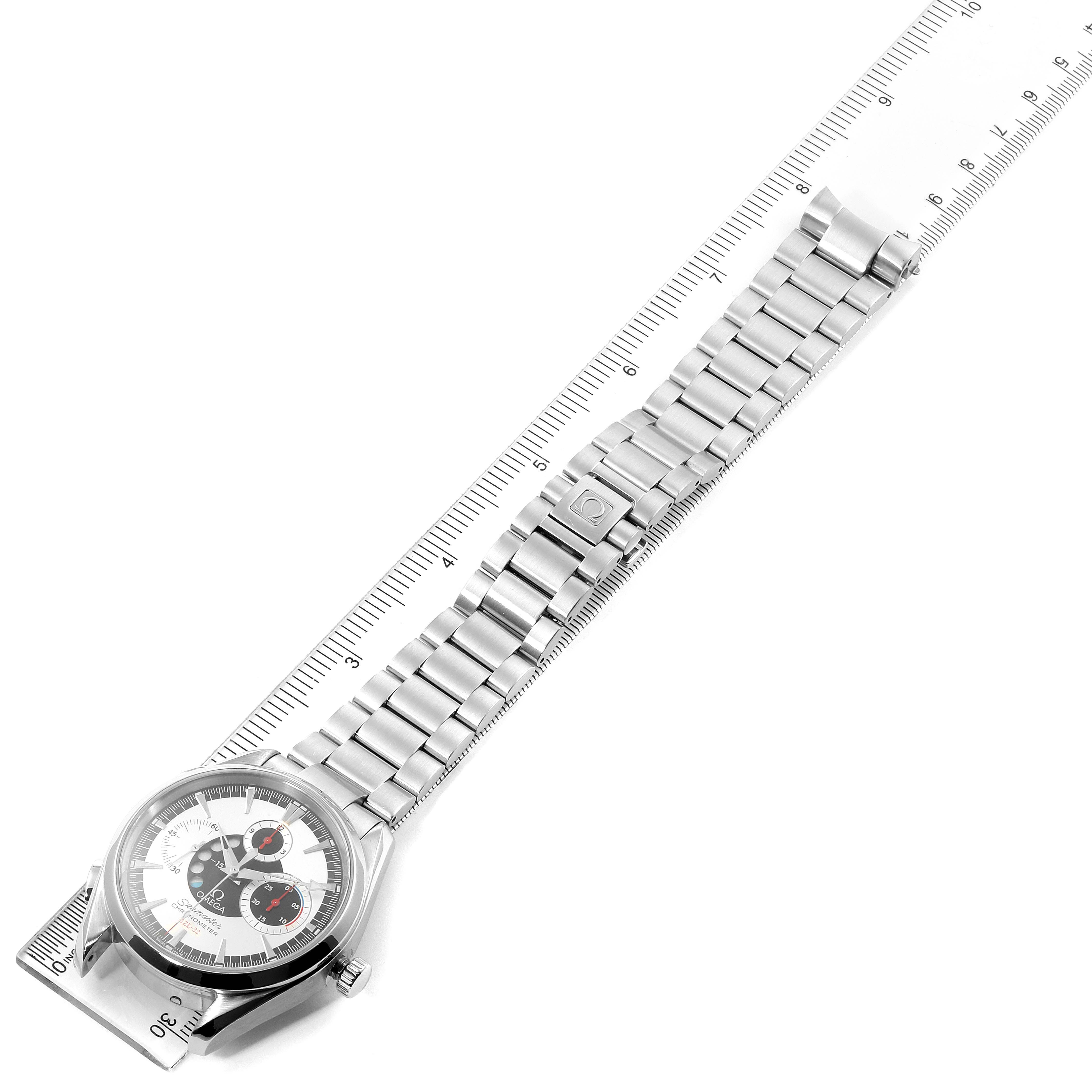 The Omega Aqua Terra 2513.30.00 Men
s Stainless Steel Silver Dial 2513.30.00 Men
s Stainless Steel Silver Dial watch is shown from a top-down angle, displaying the face, metal bracelet, and clasp on a ruler.