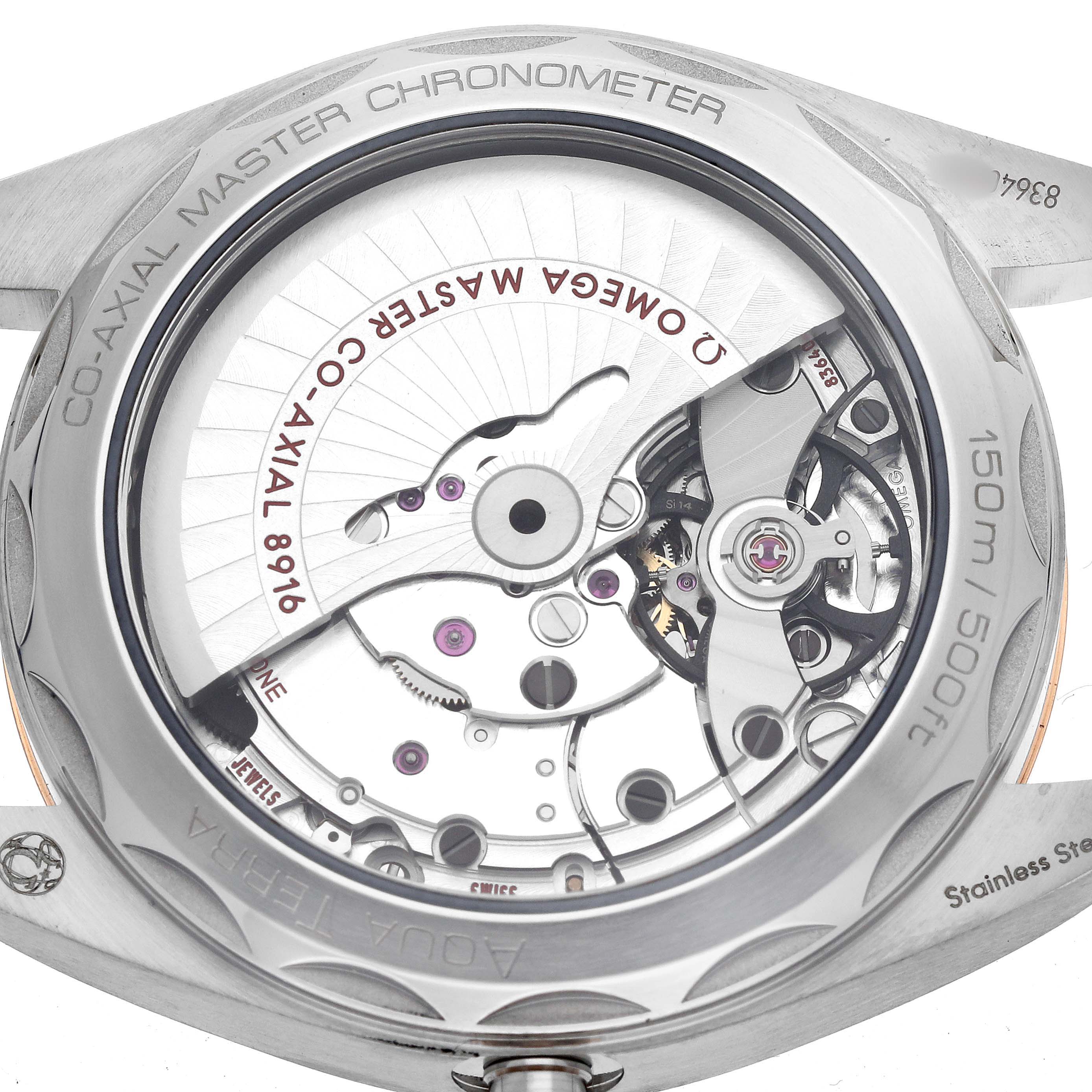 The image shows the back of the Omega Aqua Terra 220.22.41.21.03.001 Men's Steel and Gold (two tone) Blue Dial watch, revealing its intricate Co-Axial Master Chronometer movement.