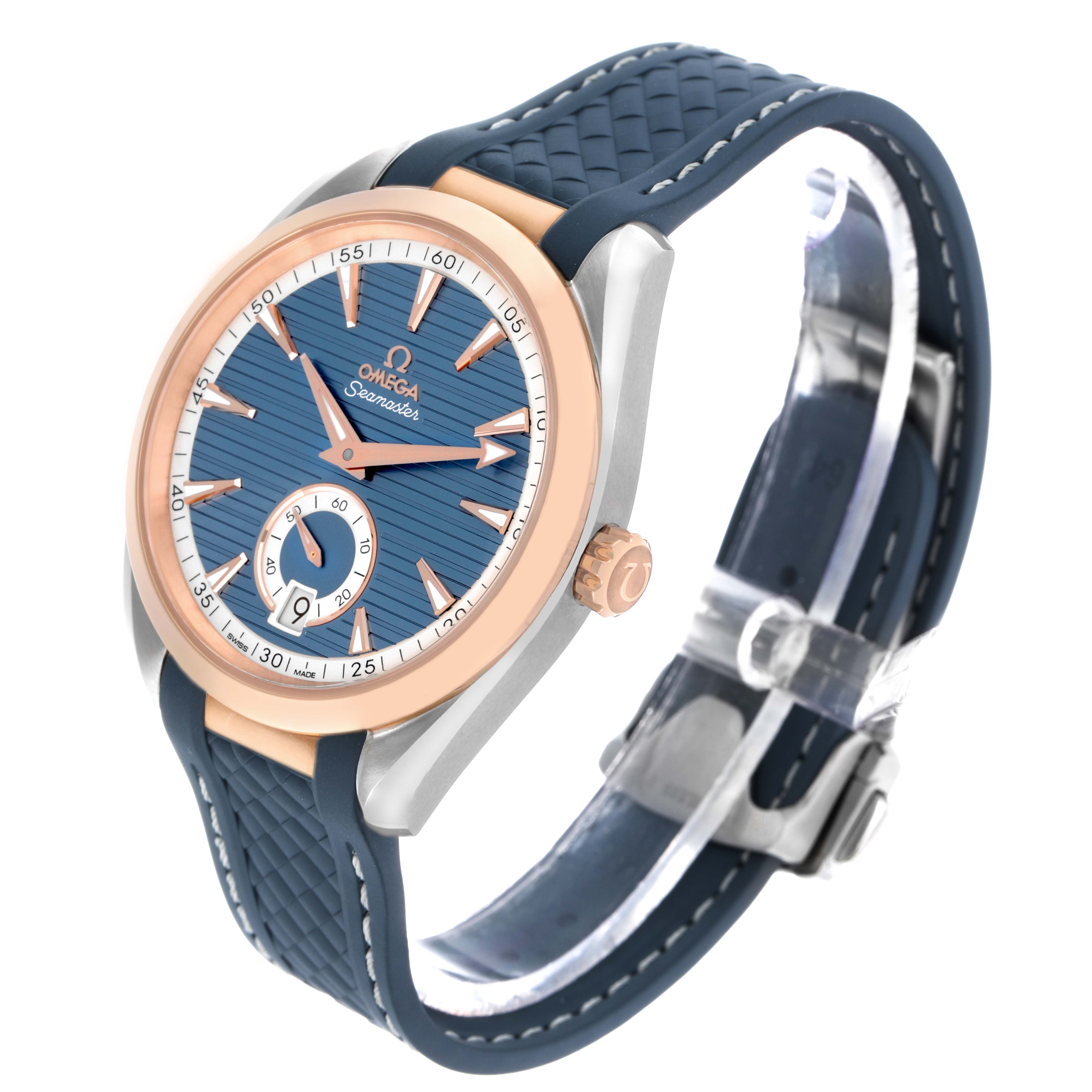 The Omega Aqua Terra 220.22.41.21.03.001 Men's Steel and Gold (two tone) Blue Dial watch is shown at a tilted angle, displaying its face, blue strap, rose gold bezel, and side crown.