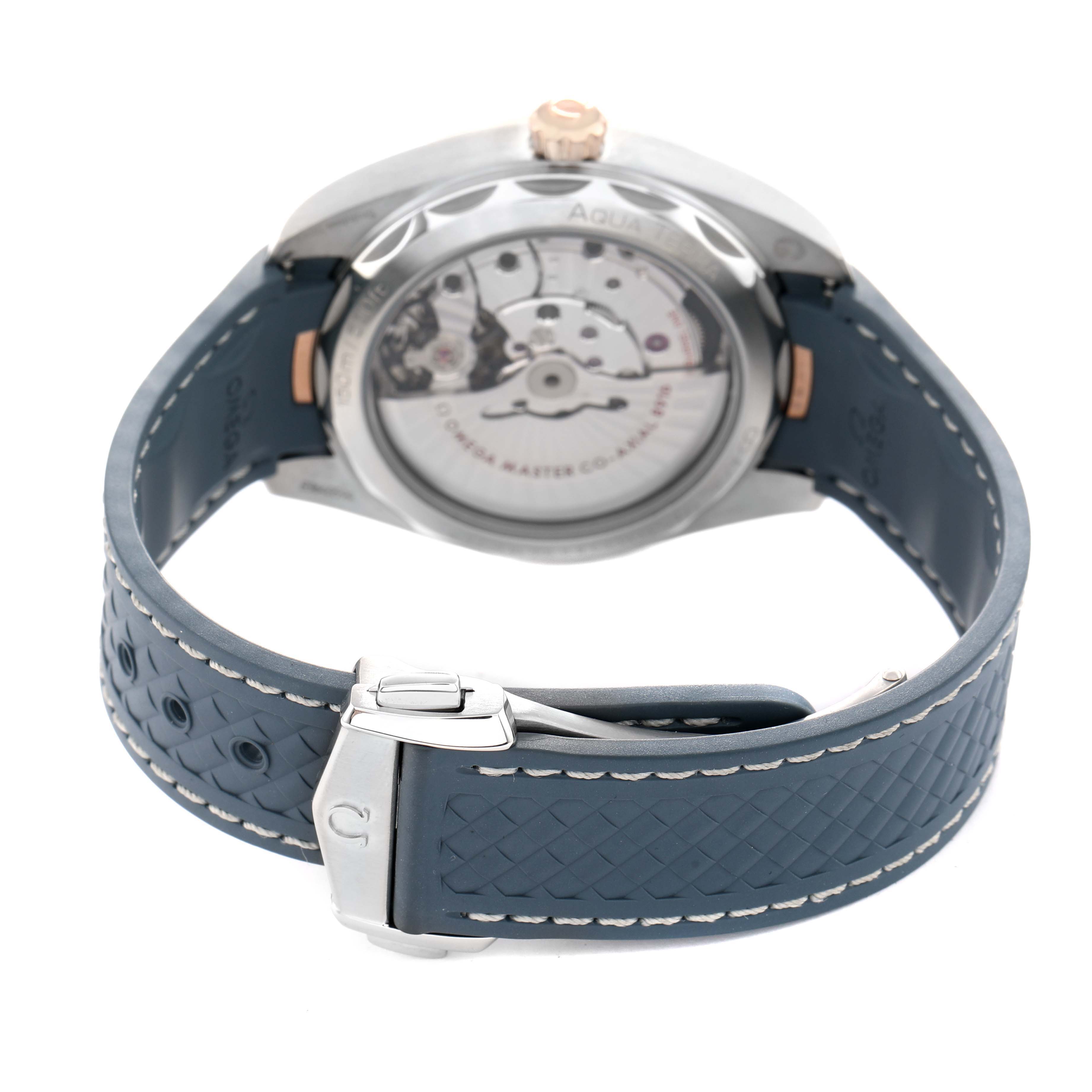 The Omega Aqua Terra 220.22.41.21.03.001 Men's Steel and Gold (two tone) Blue Dial watch is shown from the back, highlighting the transparent case back and the strap with a clasp.