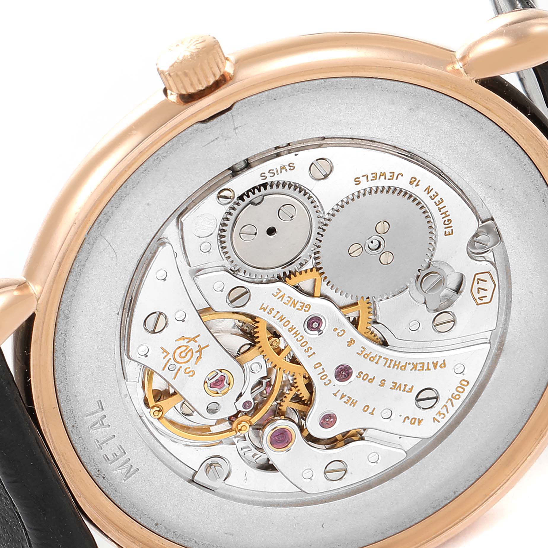 This is a close-up view of the movement at the back of a Patek Philippe Calatrava 3820 Men's Rose Gold Silver Dial 3820 Men's Rose Gold Silver Dial watch, showing its intricate gears and components.