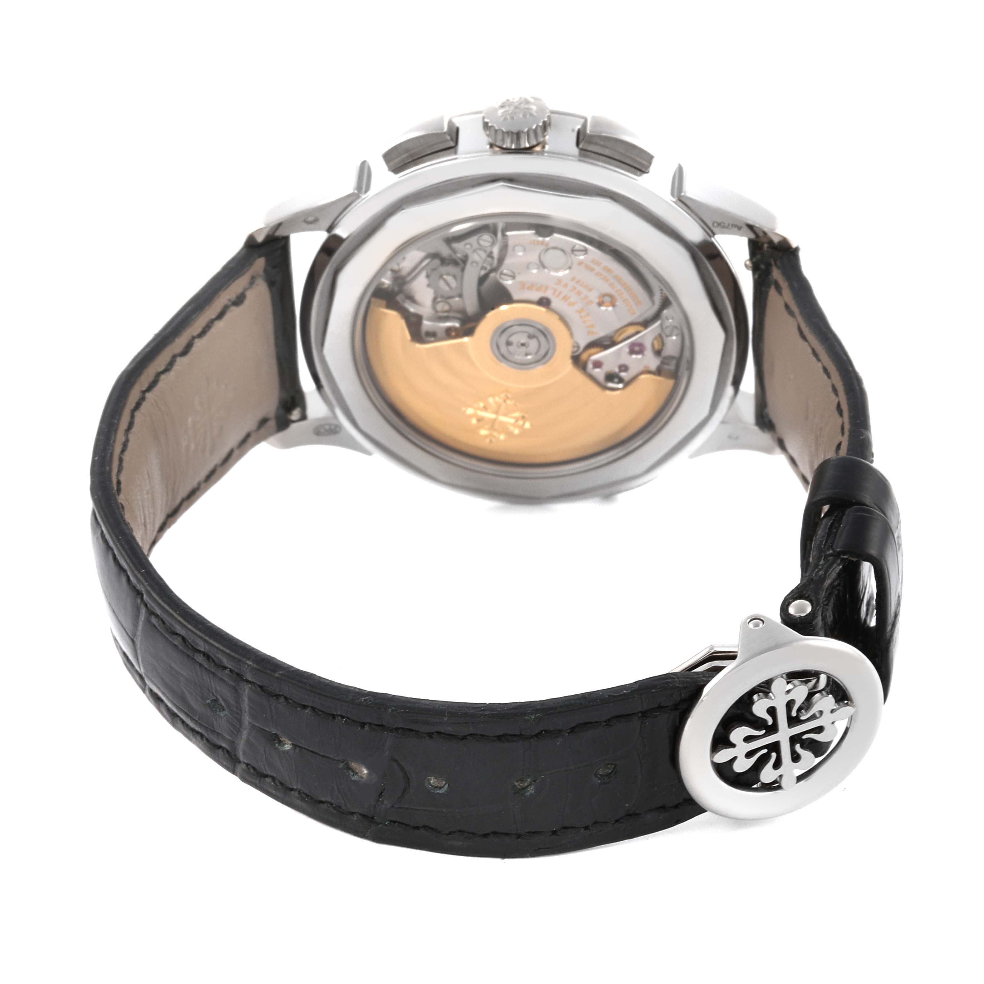 The image shows the back view of a Patek Philippe Complications 5930G-001 Men's White Gold Blue Dial 5930G-001 Men's White Gold Blue Dial watch, highlighting the movement and leather strap.