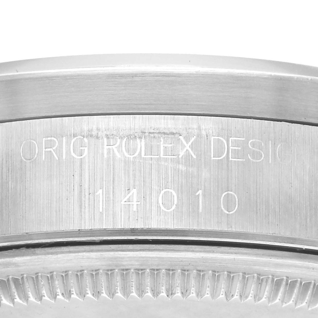 The image shows the side of a Rolex Air-King 14010 Men's Stainless Steel White Dial 14010 Men's Stainless Steel White Dial watch, focusing on the engraved model and design numbers.