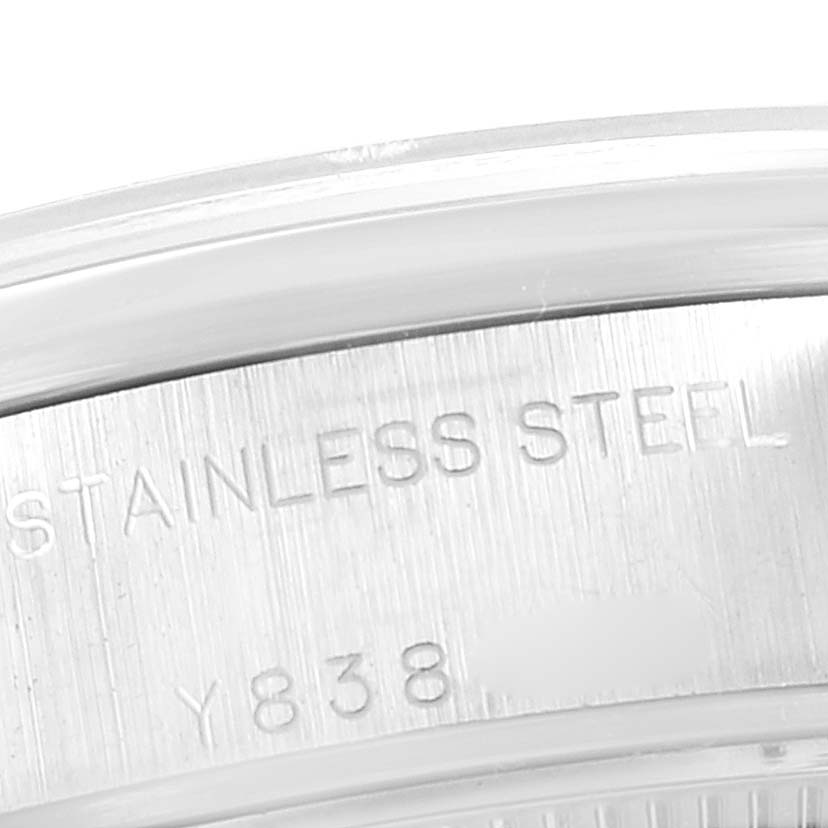 This image shows a close-up of the side case of a Rolex Date 79160 Women's Stainless Steel Pink Dial 79160 Women's Stainless Steel Pink Dial model, highlighting the "STAINLESS STEEL" engraving.