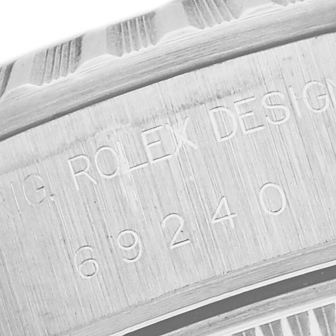 The image shows a partial close-up of the side engraving on a Rolex Date 69240 Women's Stainless Steel Black Dial 69240 Women's Stainless Steel Black Dial model.