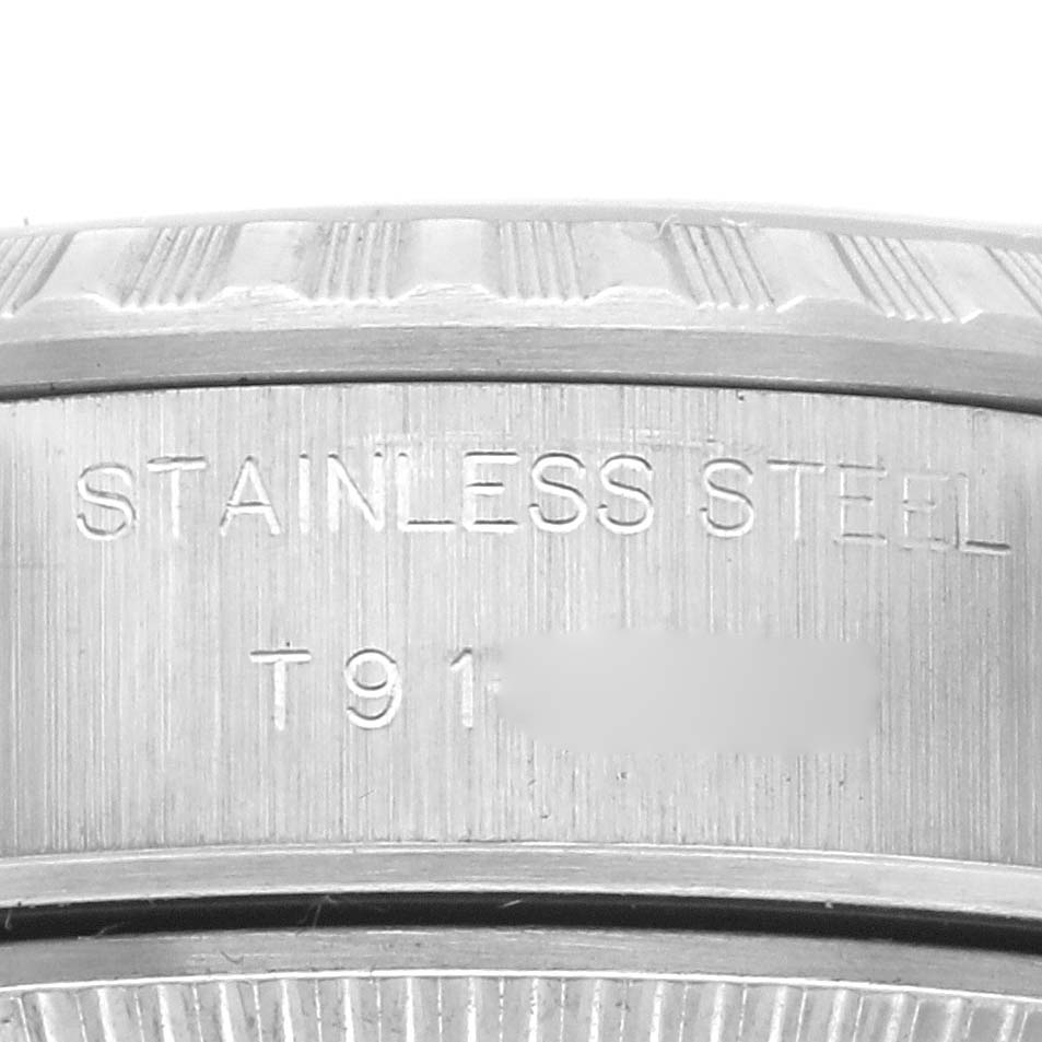 The image shows a close-up of the stainless steel edge and engravings on a Rolex Date 69240 Women's Stainless Steel Silver Dial 69240 Women's Stainless Steel Silver Dial model watch.