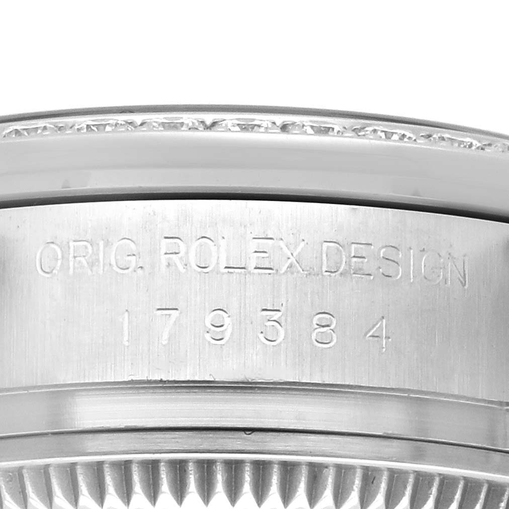 The image shows a close-up of the side of a Rolex Datejust 179384 Women's Stainless Steel White Dial 179384 Women's Stainless Steel White Dial watch, highlighting the engraved serial and model numbers.