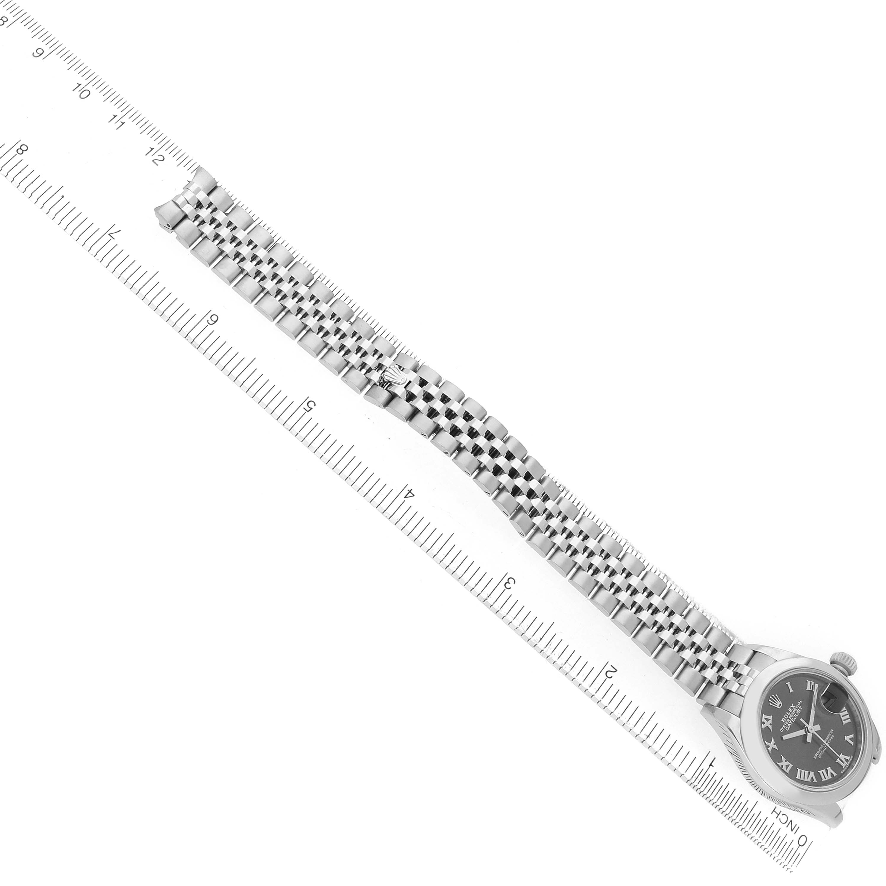 The Rolex Datejust 279160 Women's Stainless Steel Grey Dial watch is shown at an angle focusing on the bracelet and dial, alongside a ruler for scale.