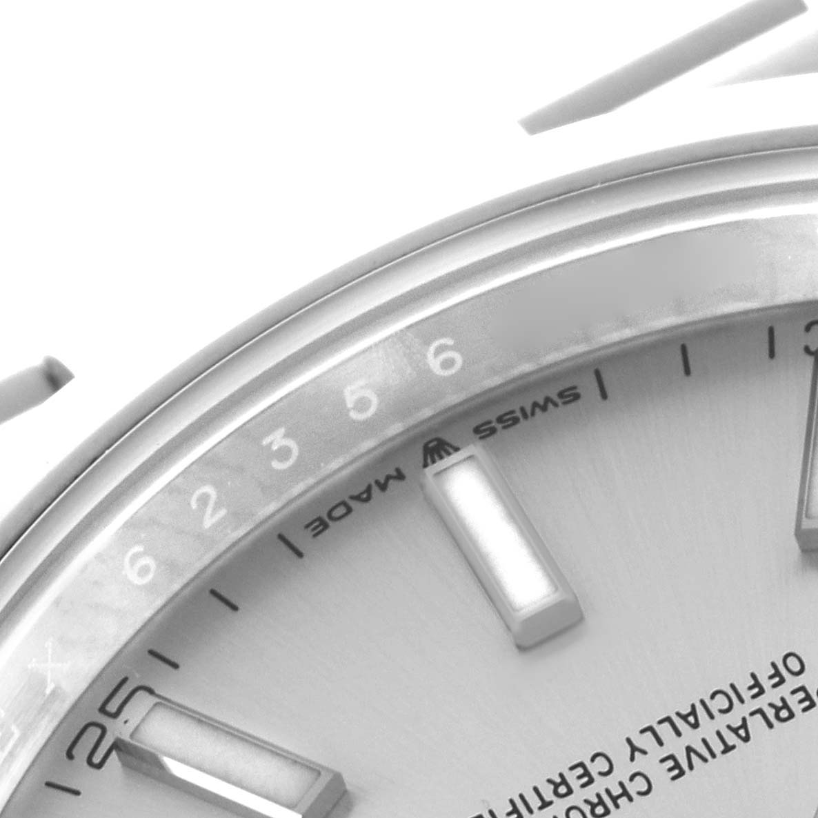 The image shows the dial
s upper left quadrant of the Rolex Datejust 126300 Men
s Stainless Steel Silver Dial 126300 Men
s Stainless Steel Silver Dial, highlighting the markers and part of the chapter ring.