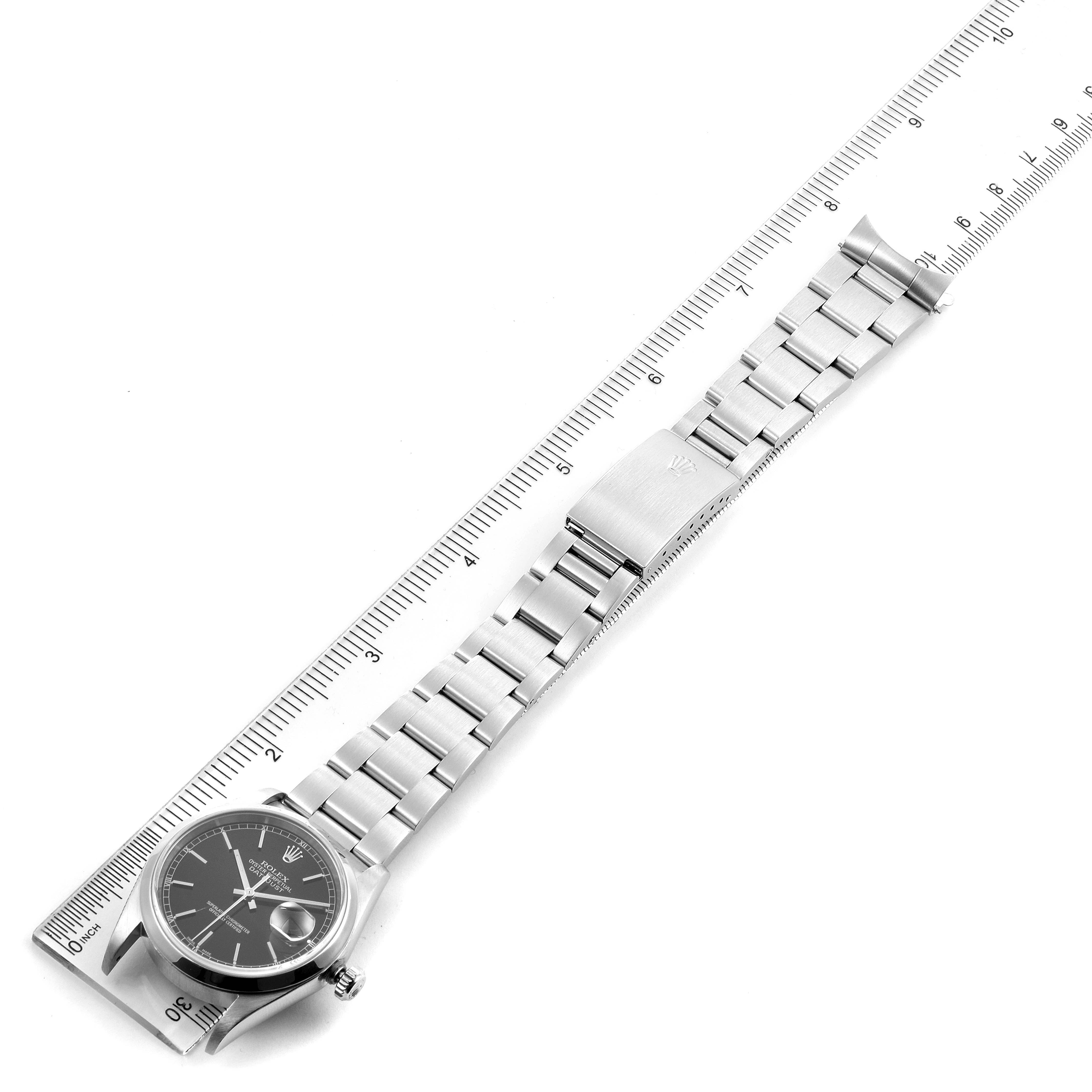 This image shows a Rolex Datejust 16200 Men's Stainless Steel Black Dial 16200 Men's Stainless Steel Black Dial watch with its bracelet laid flat against a ruler for measurement.