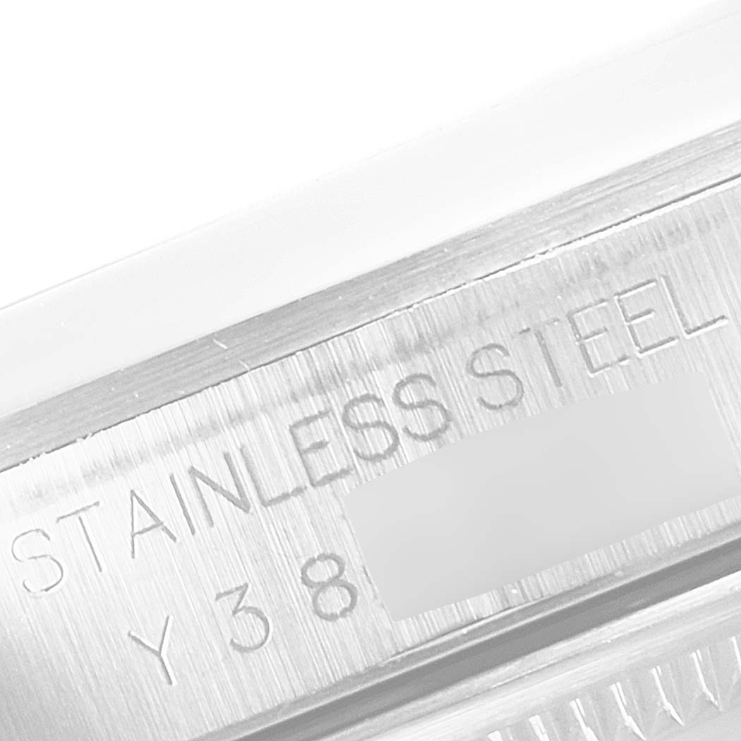 This close-up image shows the stainless steel engraving and part of the bezel on a Rolex Datejust 16200 Men's Stainless Steel Black Dial 16200 Men's Stainless Steel Black Dial watch.