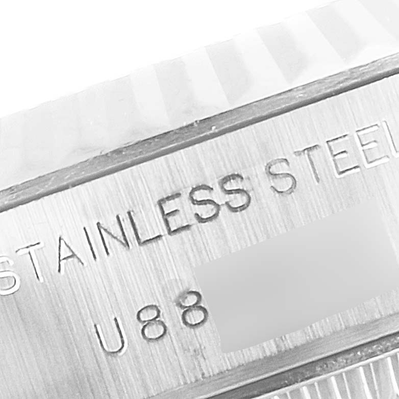 The image shows a close-up of the serial number and "STAINLESS STEEL" engraving on a Rolex Datejust 69174 Women
s Stainless Steel Pink Dial 69174 Women
s Stainless Steel Pink Dial watch.