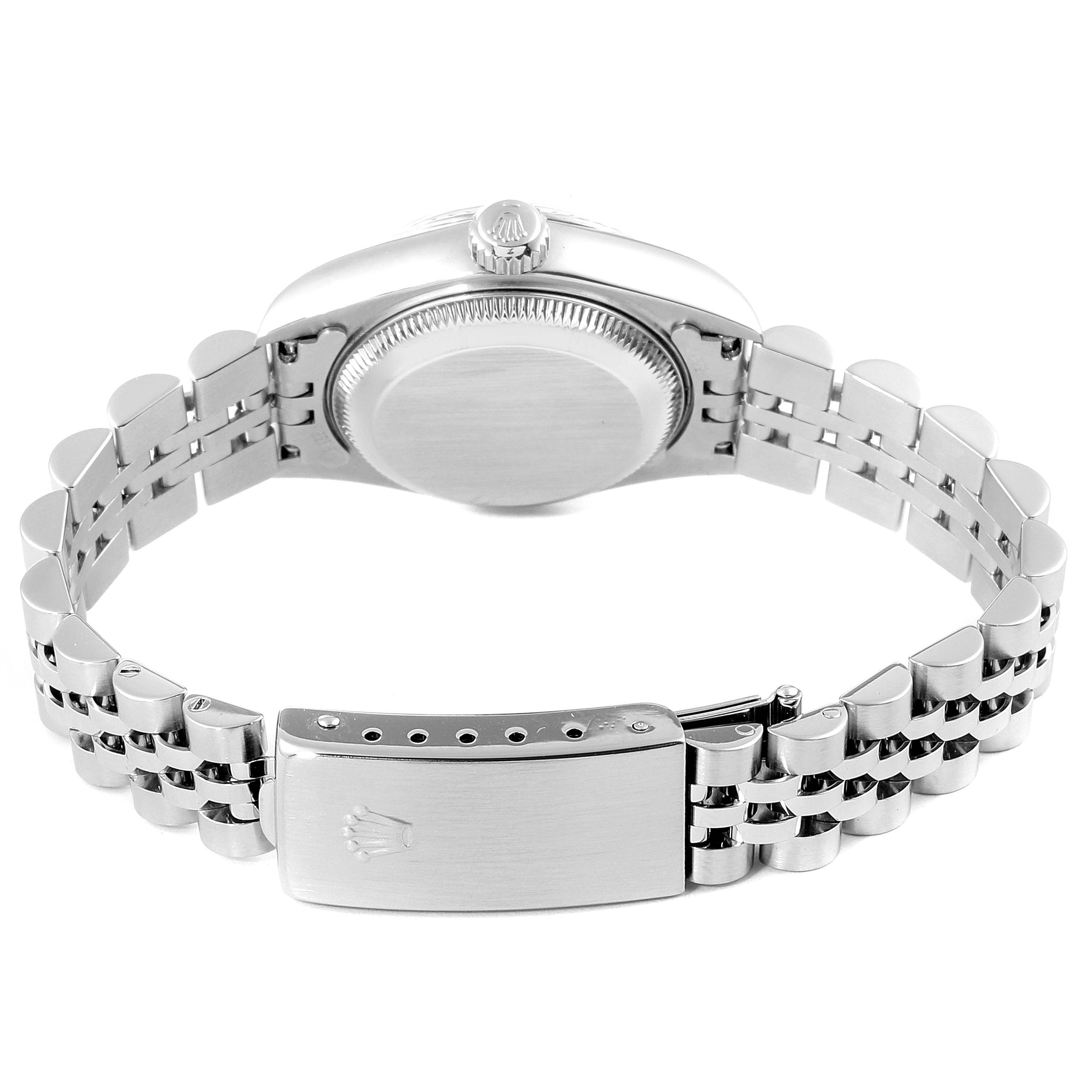 The image shows the back of the Rolex Datejust 69174 Women
s Stainless Steel Pink Dial 69174 Women
s Stainless Steel Pink Dial watch, focusing on the case, crown, and bracelet clasp.