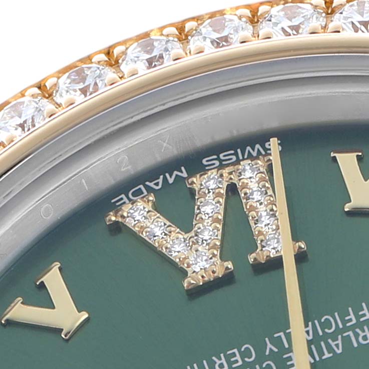 The image shows a close-up of the Rolex Mid-Size 178383 Women's Steel and Gold (two tone) Green Dial watch's dial and diamond-encrusted bezel from a top angle.