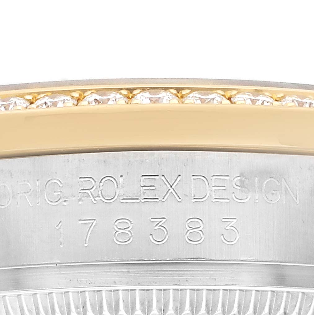 The image shows the edge and side engraving of a Rolex Mid-Size 178383 Women's Steel and Gold (two tone) Green Dial model, highlighting part of the bezel and case.