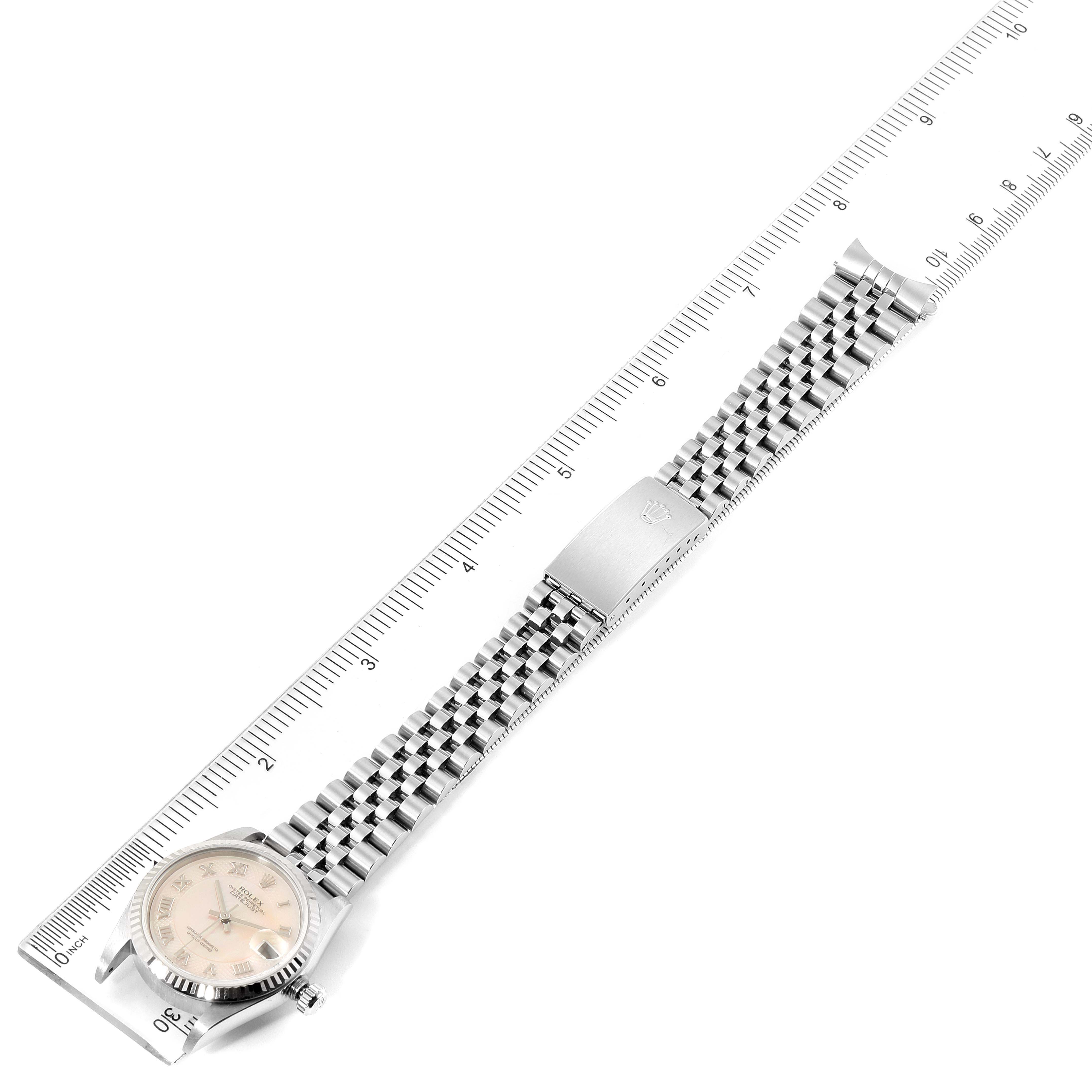 The image shows a Rolex Mid-Size 78274 Women
s Stainless Steel Mother of Pearl Dial 78274 Women
s Stainless Steel Mother of Pearl Dial watch laid flat, measured against a ruler, displaying its bracelet, clasp, and face.