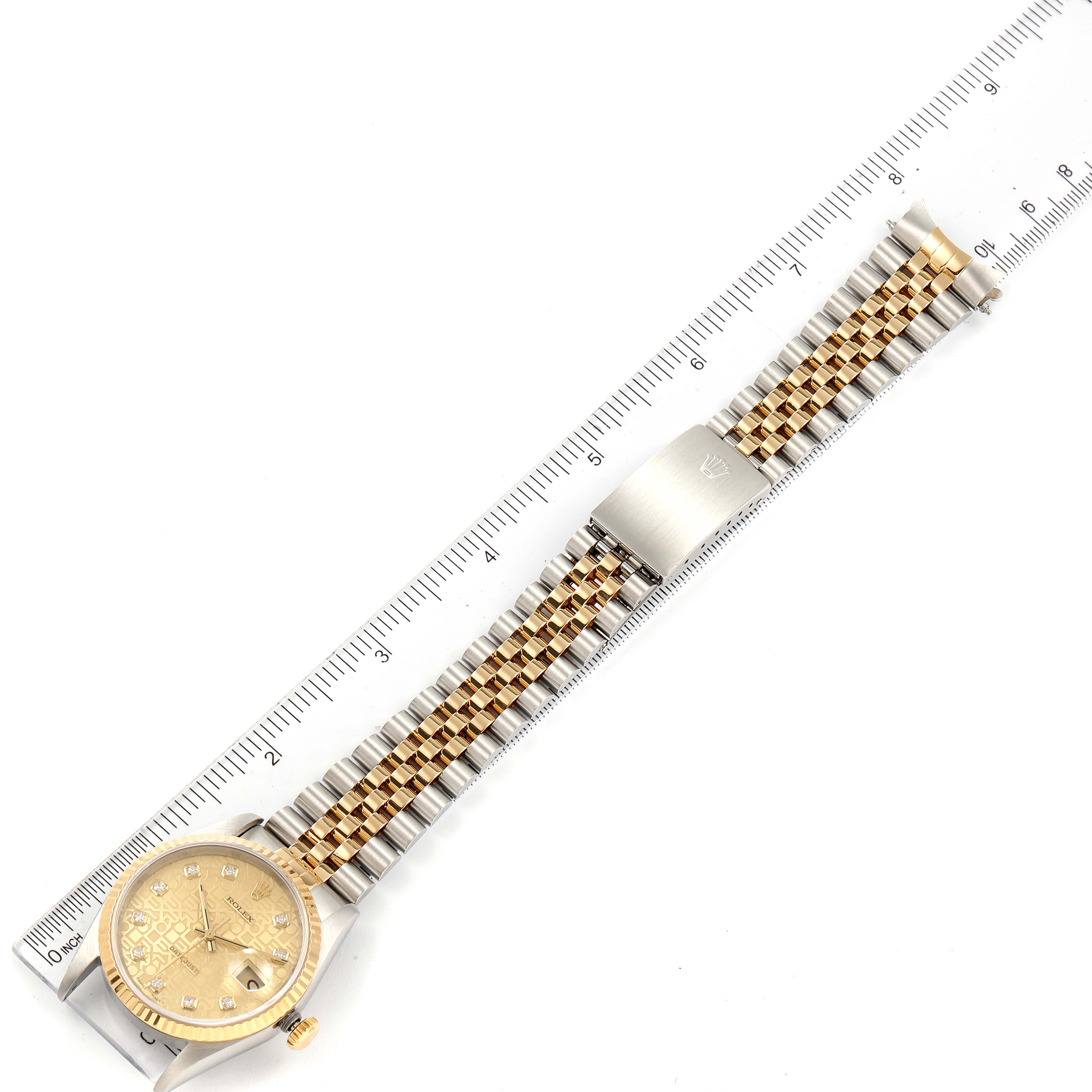 The image shows a full side view of the Rolex Datejust 16233 Men's Steel and Gold (two tone) Champagne Dial 16233 Men's Steel and Gold (two tone) Champagne Dial watch laid next to a ruler, displaying its face and two-tone bracelet.