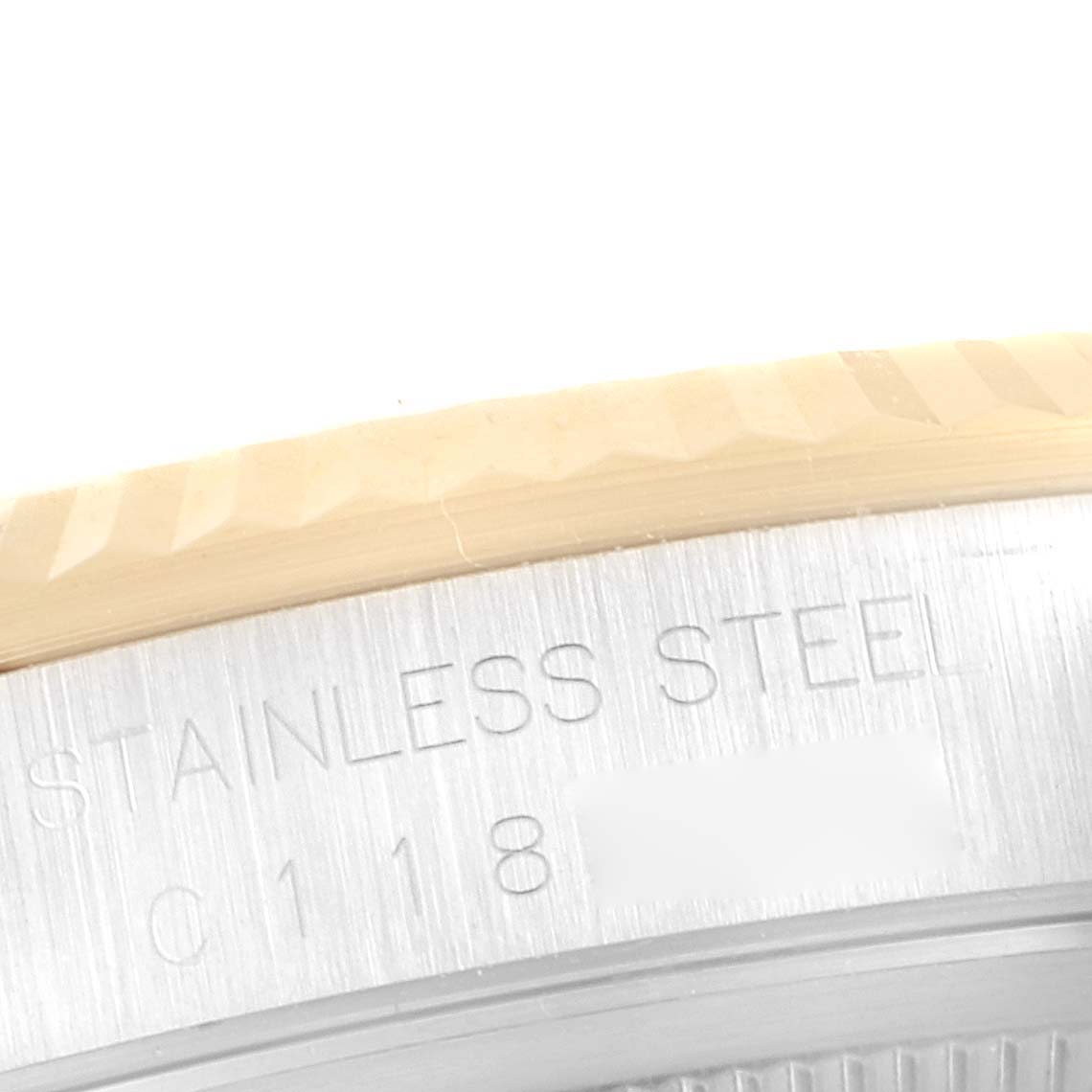This image shows a close-up of the stainless steel case back edge and part of the bezel of a Rolex Datejust 16233 Men's Steel and Gold (two tone) Black Dial 16233 Men's Steel and Gold (two tone) Black Dial watch.