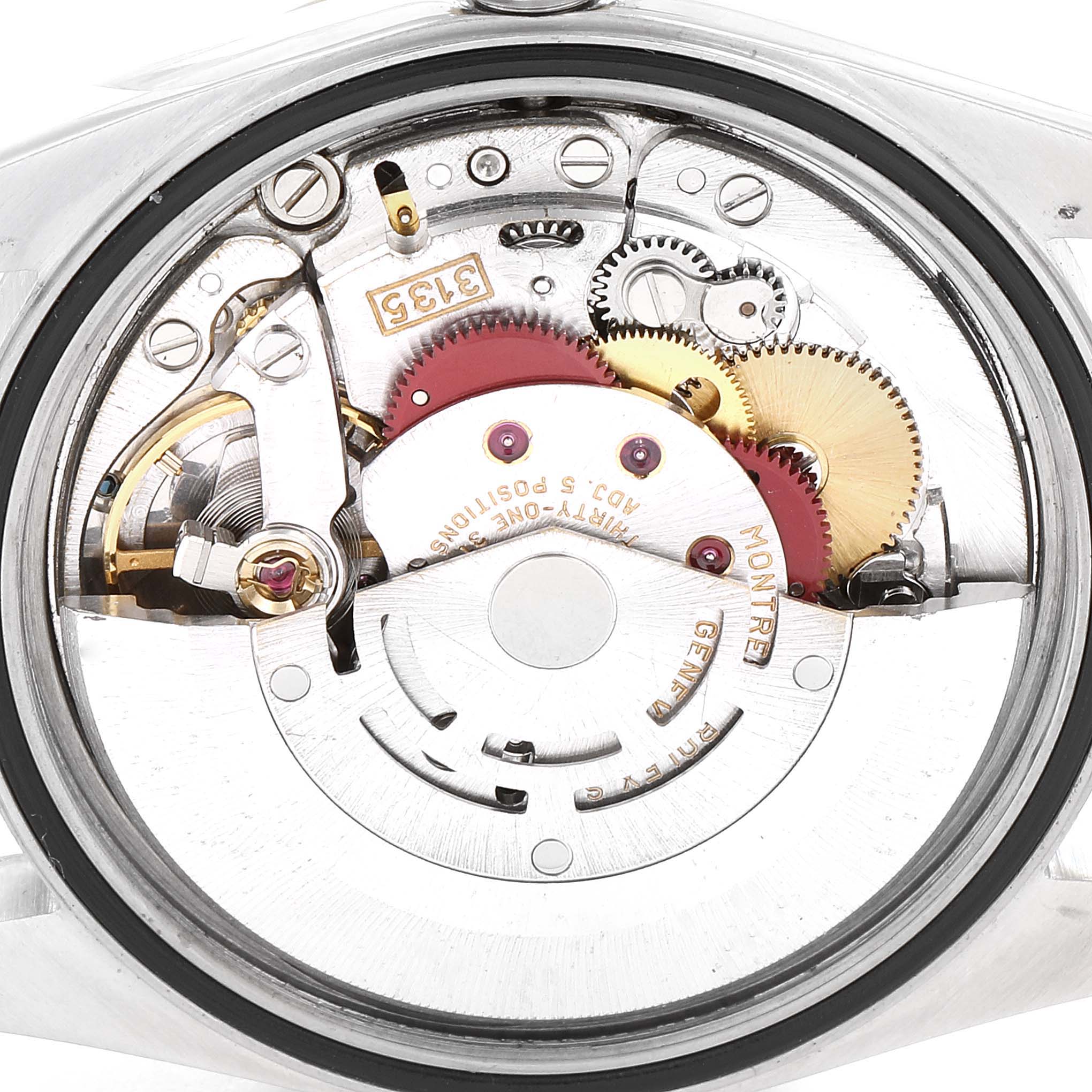 This is a close-up view of the Rolex Datejust 16233 Men's Steel and Gold (two tone) Black Dial 16233 Men's Steel and Gold (two tone) Black Dial model's movement, showcasing its intricate mechanical components and gears.