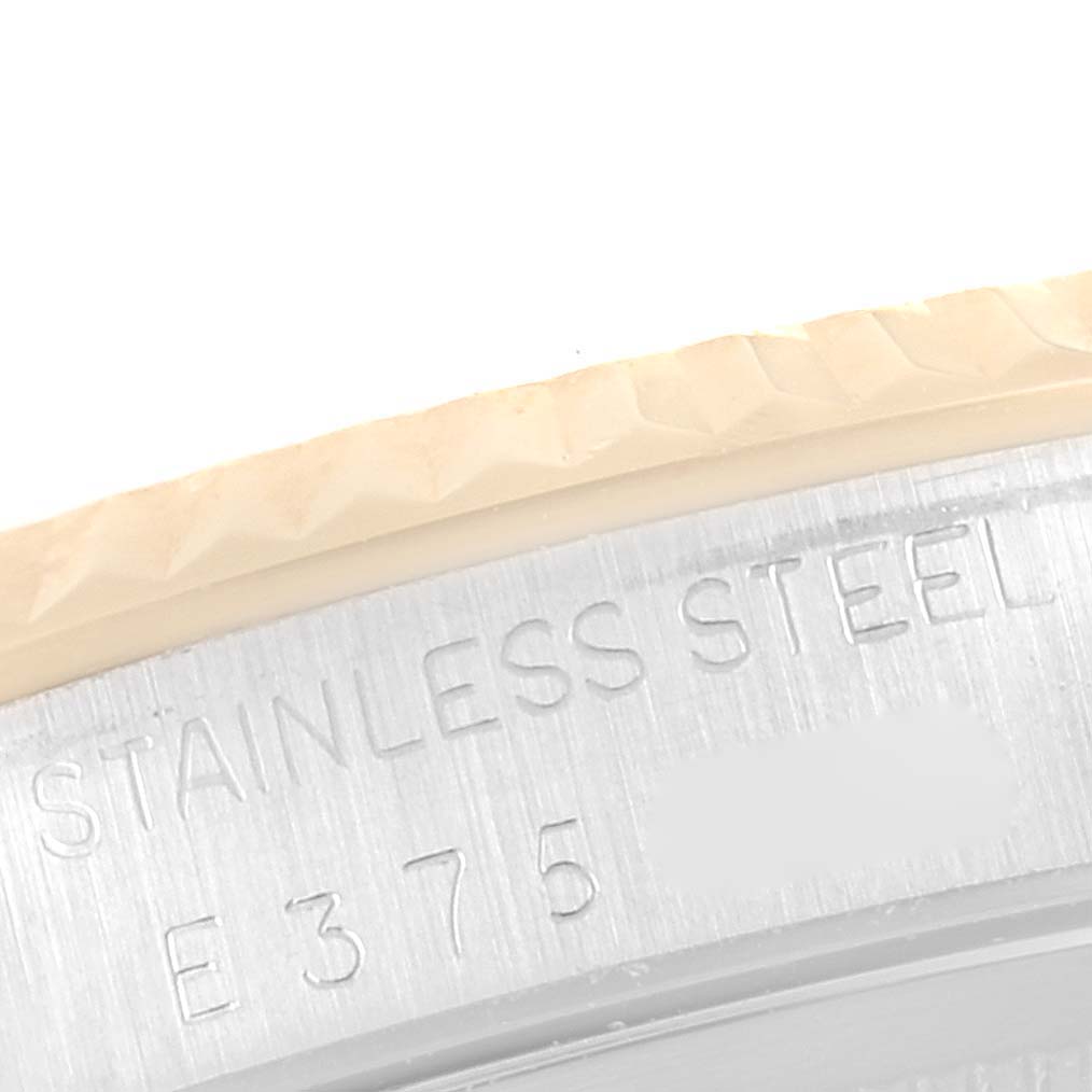 This image shows a close-up of the stainless steel bezel and engravings on the Rolex Datejust 16233 Men's Steel and Gold (two tone) Black Dial 16233 Men's Steel and Gold (two tone) Black Dial model.