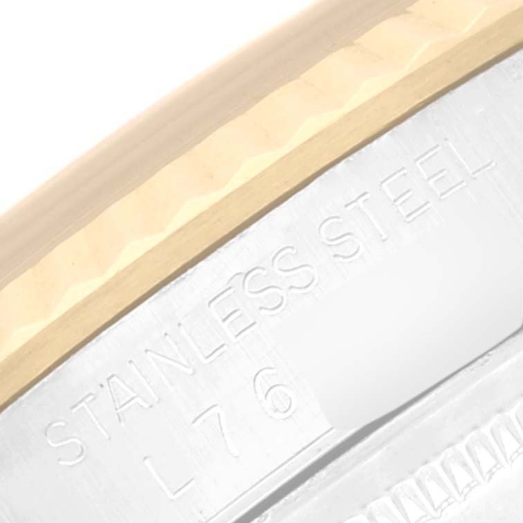 This close-up image of a Rolex Datejust 16233 Men's Steel and Gold (two tone) Champagne Dial 16233 Men's Steel and Gold (two tone) Champagne Dial watch shows the stainless steel engraving on the case edge.