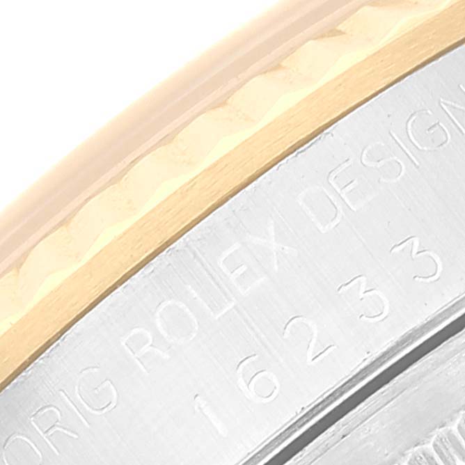 This close-up image of a Rolex Datejust 16233 Men's Steel and Gold (two tone) Champagne Dial 16233 Men's Steel and Gold (two tone) Champagne Dial watch shows part of the case with "ORIG ROLEX DESIGN" and model number 16233 engraved.