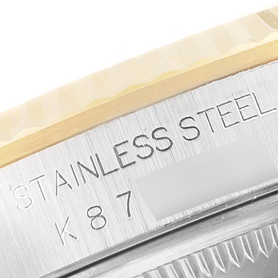 The image shows a close-up of the side of a Rolex Datejust 16233 Men's Steel and Gold (two tone) Silver Dial 16233 Men's Steel and Gold (two tone) Silver Dial watch, highlighting the stainless steel engraving and bezel.