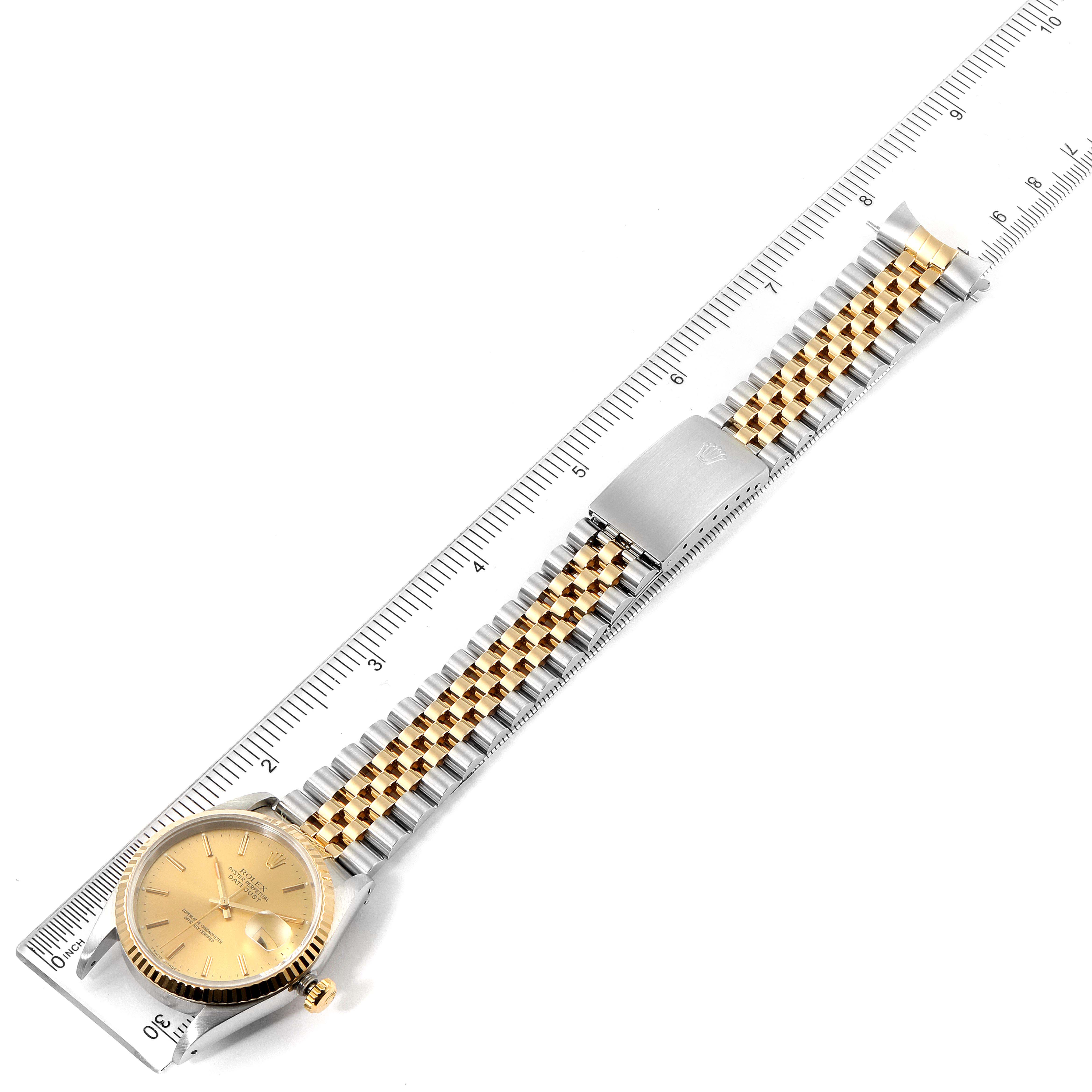 The image shows a Rolex Datejust 16233 Men's Steel and Gold (two tone) Champagne Dial 16233 Men's Steel and Gold (two tone) Champagne Dial watch laid flat, highlighting its gold dial, fluted bezel, and two-tone jubilee bracelet with clasp.