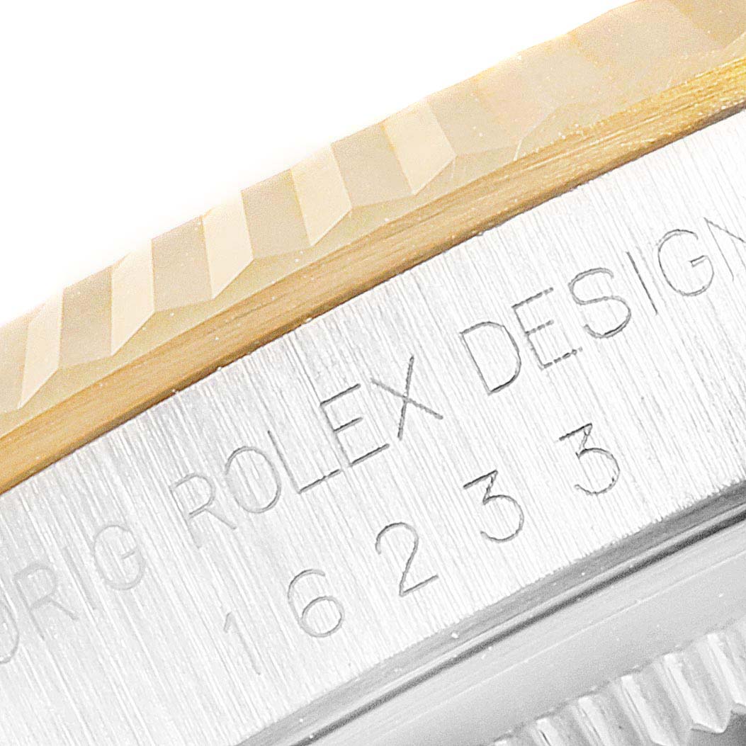 The image shows a close-up of the bezel and part of the case back of a Rolex Datejust 16233 Men's Steel and Gold (two tone) Champagne Dial 16233 Men's Steel and Gold (two tone) Champagne Dial model with its design number engraved.