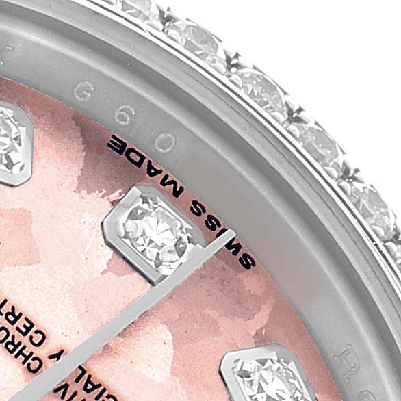 The image shows a close-up of the Rolex Datejust 179384 Women's Stainless Steel Pink Dial's dial with diamond markers and a diamond-studded bezel.