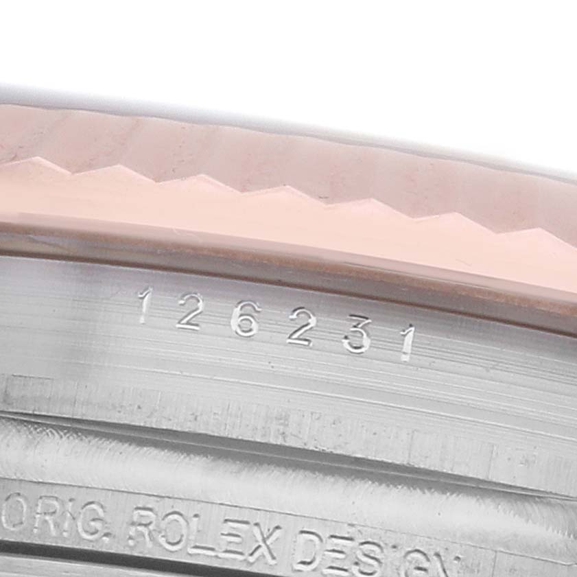 The image shows a close-up of the Rolex Datejust 126231 Men's Steel and Gold (two tone) Mother of Pearl Dial model's fluted bezel and engraved edge with model and design details.