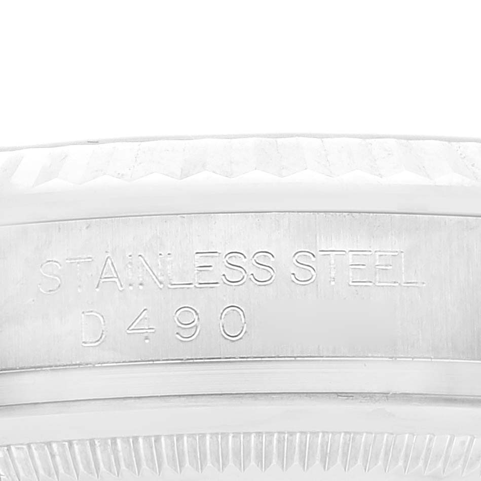 This image shows an angled close-up of the stainless steel bezel and case serial engraving on a Rolex Datejust 116234 Men's Stainless Steel Blue Dial 116234 Men's Stainless Steel Blue Dial watch.