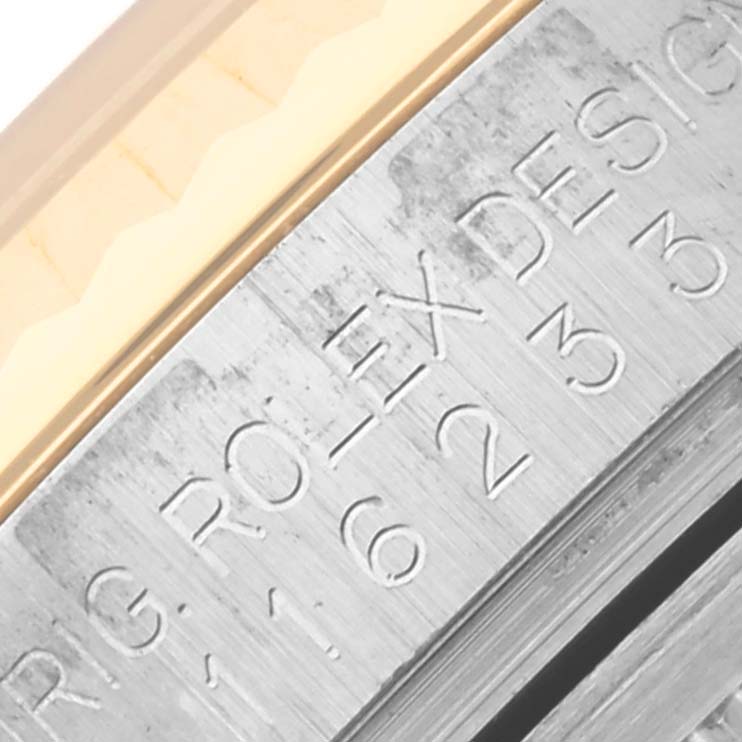 The image shows a close-up of the engraved inner bezel of a Rolex Datejust 116233 Men
s Steel and Gold (two tone) Champagne Dial 116233 Men
s Steel and Gold (two tone) Champagne Dial watch.