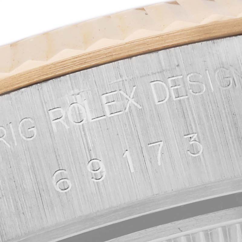 The image shows a close-up of the bezel and engraving on the side of a Rolex Datejust 69173 Women's Steel and Gold (two tone) Black Dial 69173 Women's Steel and Gold (two tone) Black Dial watch.