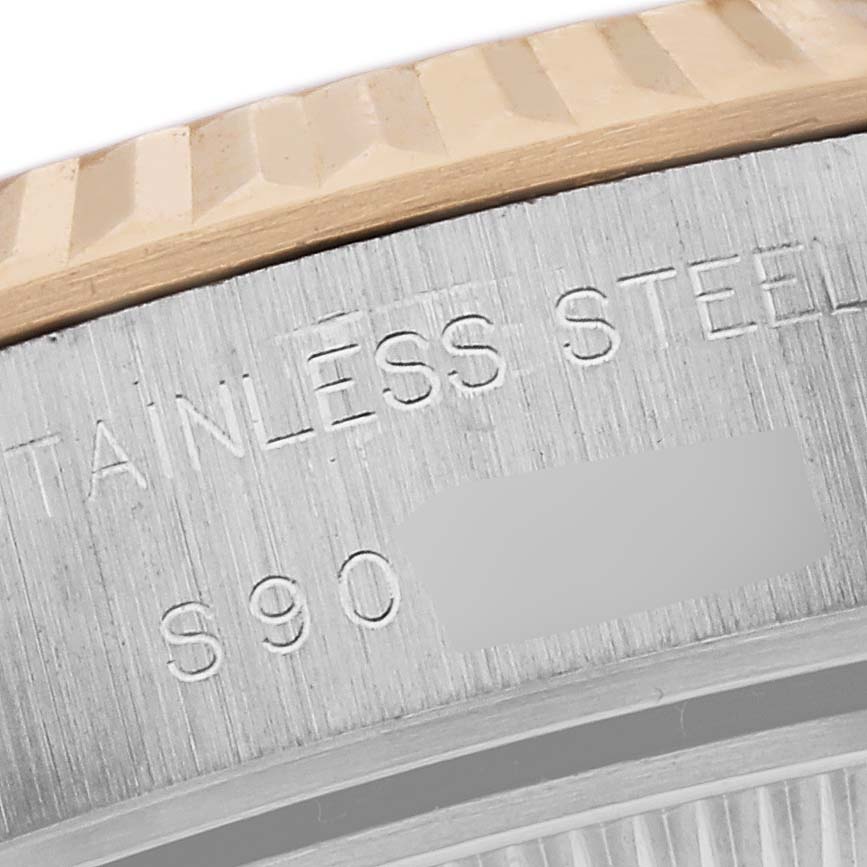 The image shows a close-up of the Rolex Datejust 69173 Women's Steel and Gold (two tone) Black Dial 69173 Women's Steel and Gold (two tone) Black Dial model focusing on the engraved case edge and part of the bezel.