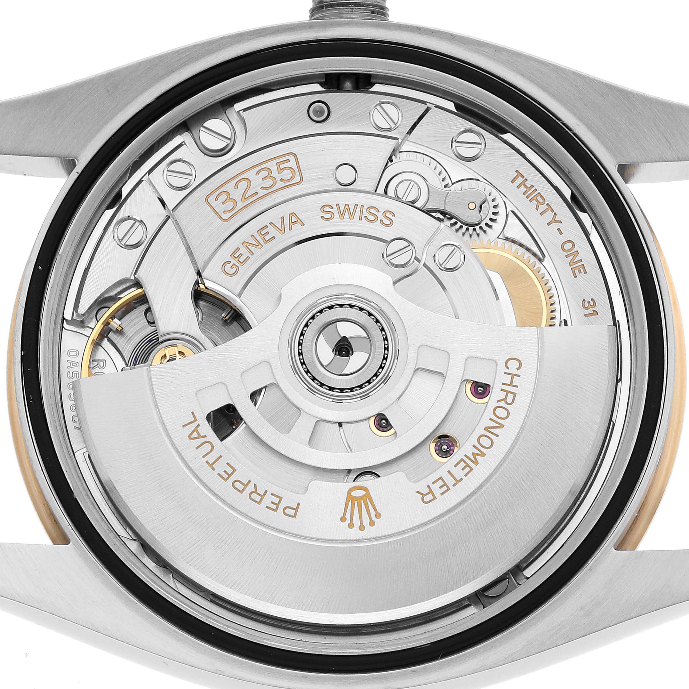 The image shows the movement of a Rolex Datejust 126203 Men's Stainless Steel Champagne Dial watch from the back, highlighting gears and the oscillating weight.