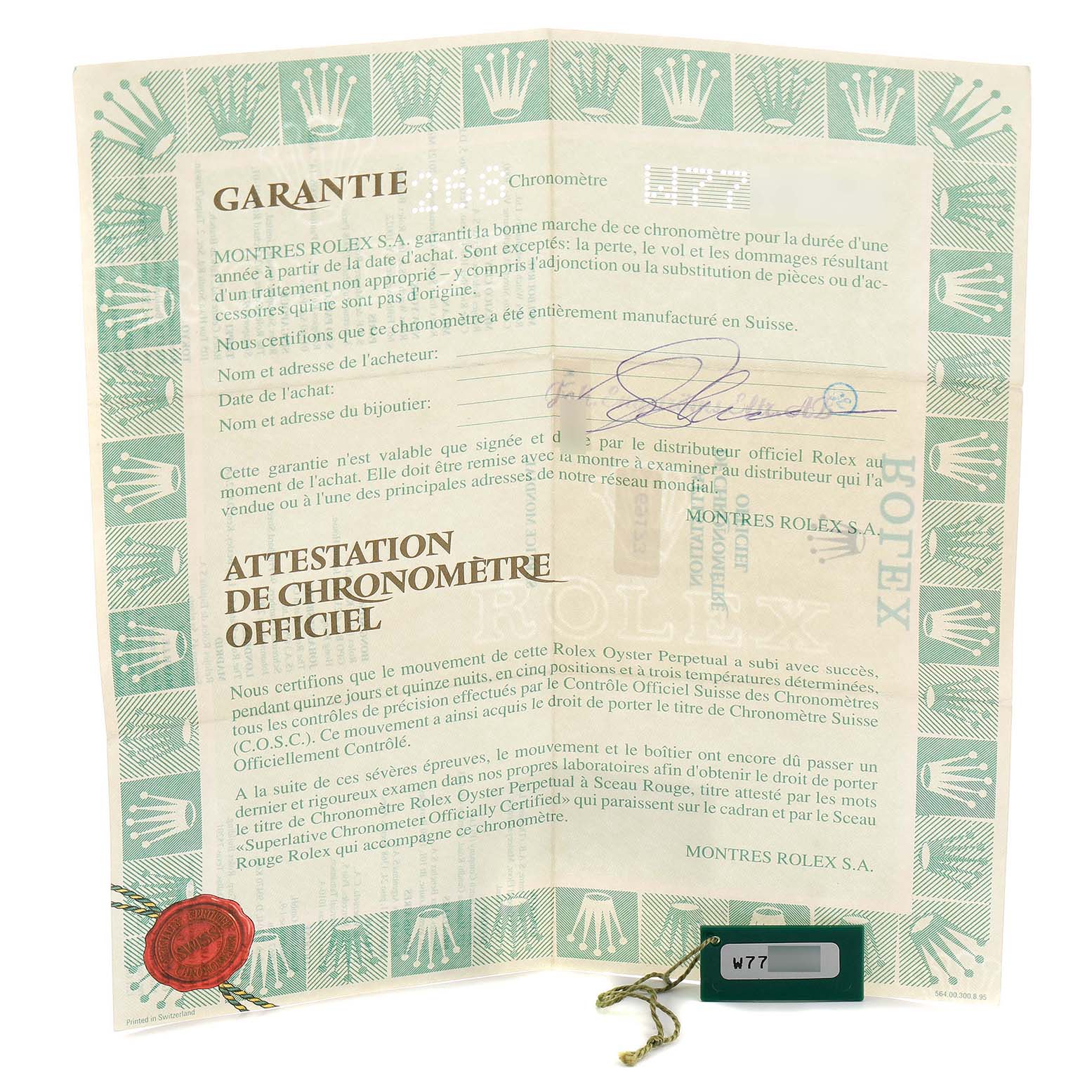 The image shows the Rolex Datejust 69173 Women's Steel and Gold (two tone) Champagne Dial warranty and chronometer certificate with a green tag and seal, viewed from above.