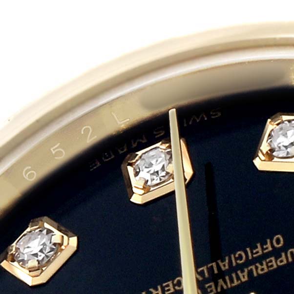 The image shows a close-up of the Rolex Datejust 179173 Women's Steel and Gold (two tone) Black Dial dial, featuring diamond hour markers and part of the watch's bezel.