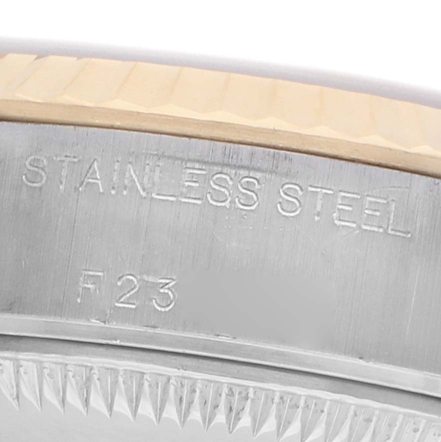 The image shows a close-up of the side of a Rolex Datejust 79173 Women's Steel and Gold (two tone) Black Dial watch, displaying the "STAINLESS STEEL" engraving and part of the bezel.