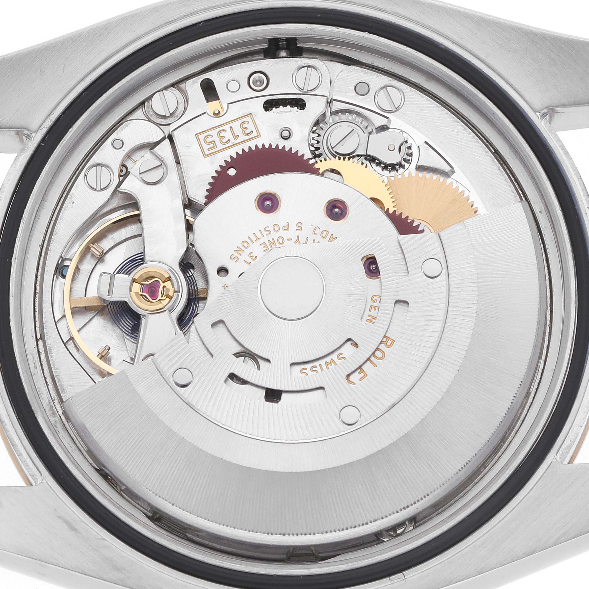 The image shows a close-up of the Rolex Datejust 116233 Men's Steel and Gold (two tone) Silver Dial's movement from the back, highlighting gears and the rotor.