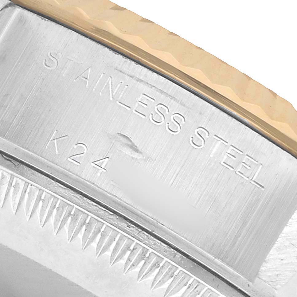 The image shows a close-up of the stainless steel case and fluted bezel of a Rolex Datejust 79163 Women's Steel and Gold (two tone) Silver Dial watch.