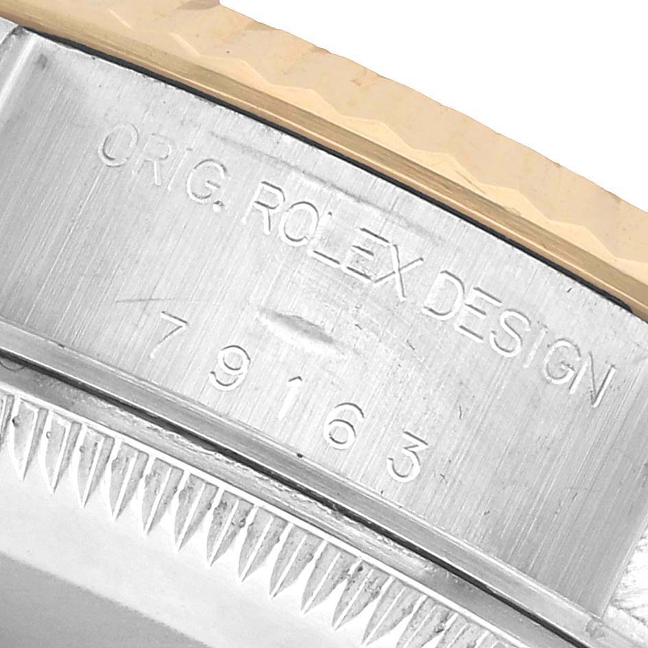 The image shows a close-up of the bezel and engraved model number of a Rolex Datejust 79163 Women's Steel and Gold (two tone) Silver Dial watch.