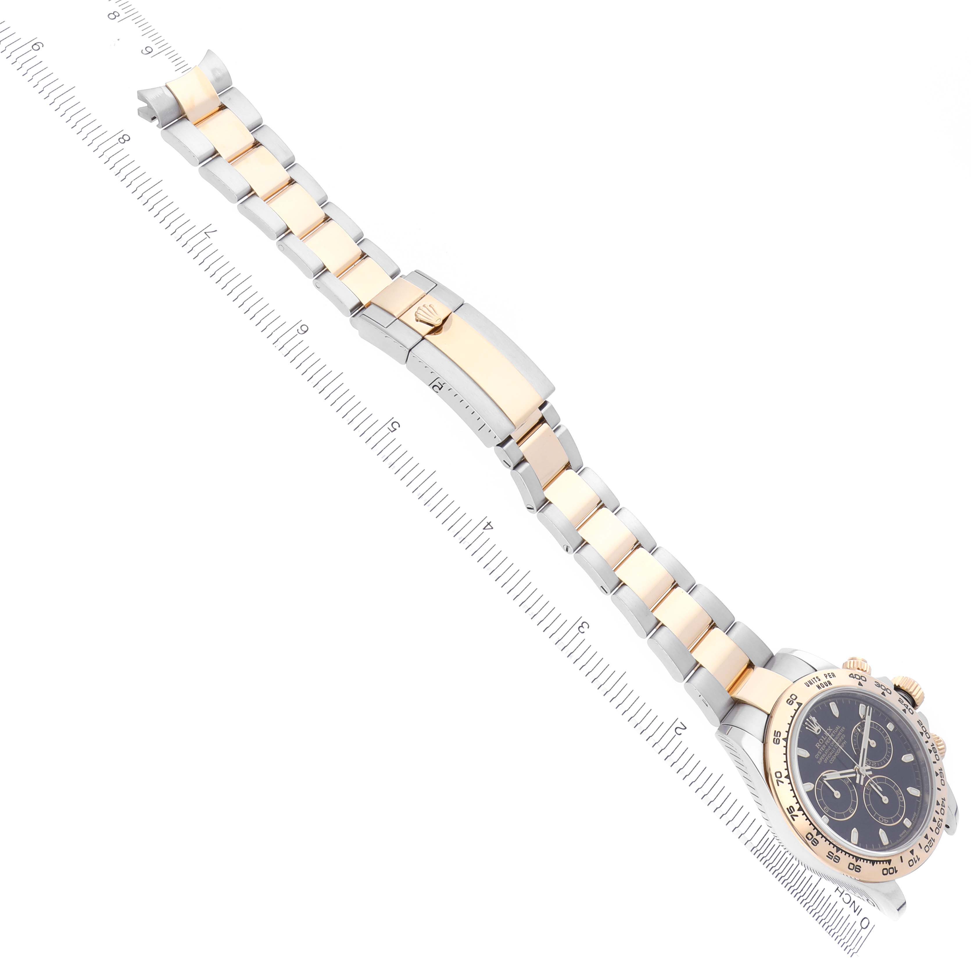 The Rolex Daytona 116503 Men
s Steel and Gold (two tone) Black Dial 116503 Men
s Steel and Gold (two tone) Black Dial watch is shown from a top-down angle, featuring the bracelet and clasp with the dial partially visible.