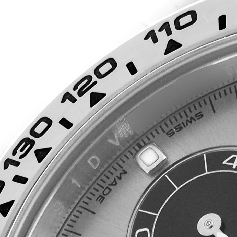 The image shows a close-up of the bezel and part of the dial of a Rolex Daytona 116509 Men
s White Gold Grey Dial 116509 Men
s White Gold Grey Dial watch.