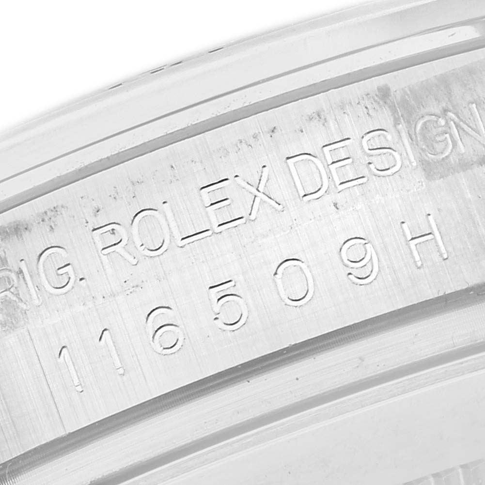 The image shows an angled close-up of the engraved case edge of a Rolex Daytona 116509 Men
s White Gold Grey Dial 116509 Men
s White Gold Grey Dial, highlighting the model number.