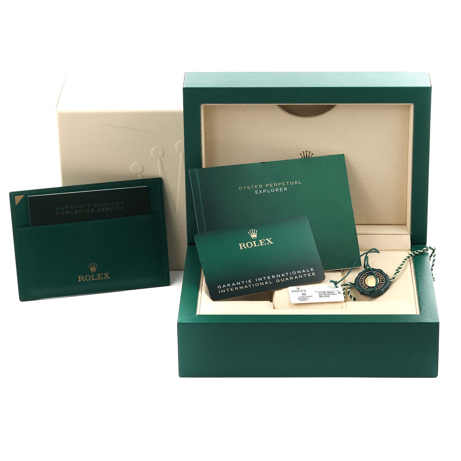 The image shows a Rolex Explorer 214270 Men
s Stainless Steel Black Dial 214270 Men
s Stainless Steel Black Dial box with booklets, a warranty card, and tags, but not the watch itself.