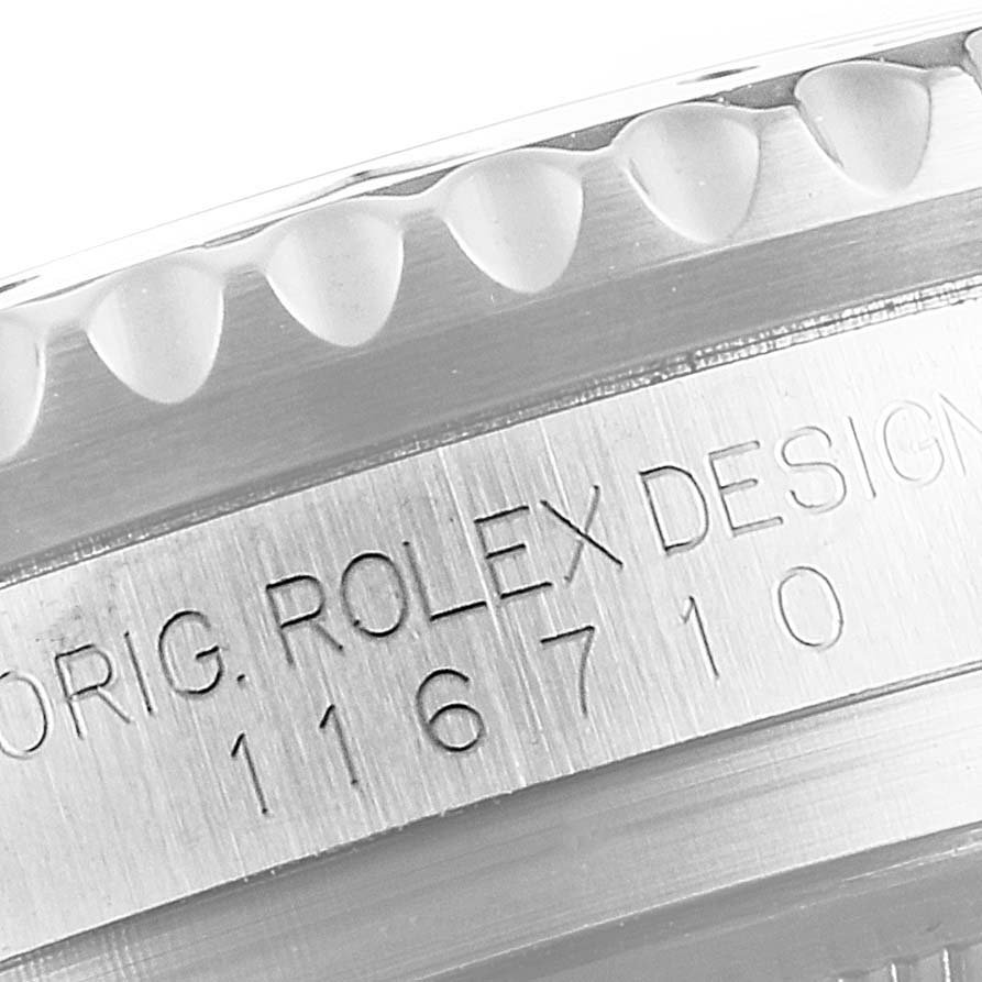 A macro close-up of the bezel and engraved serial number on a Rolex GMT-Master 116710 Men
s Stainless Steel Black Dial 116710 Men
s Stainless Steel Black Dial.
