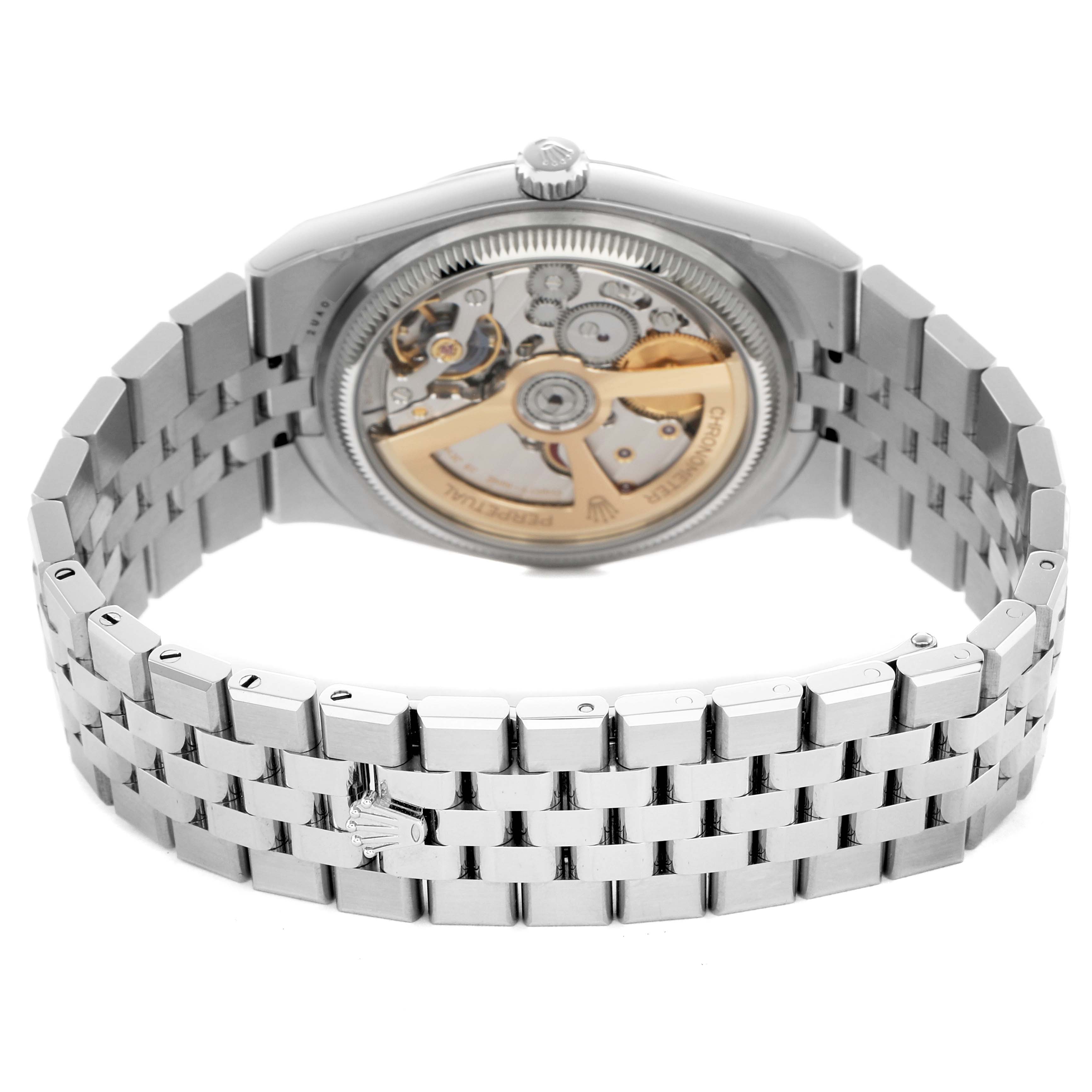 The image shows the back and side of a Rolex Land‑Dweller 127234 Men's Stainless Steel White Dial, displaying the movement and bracelet.