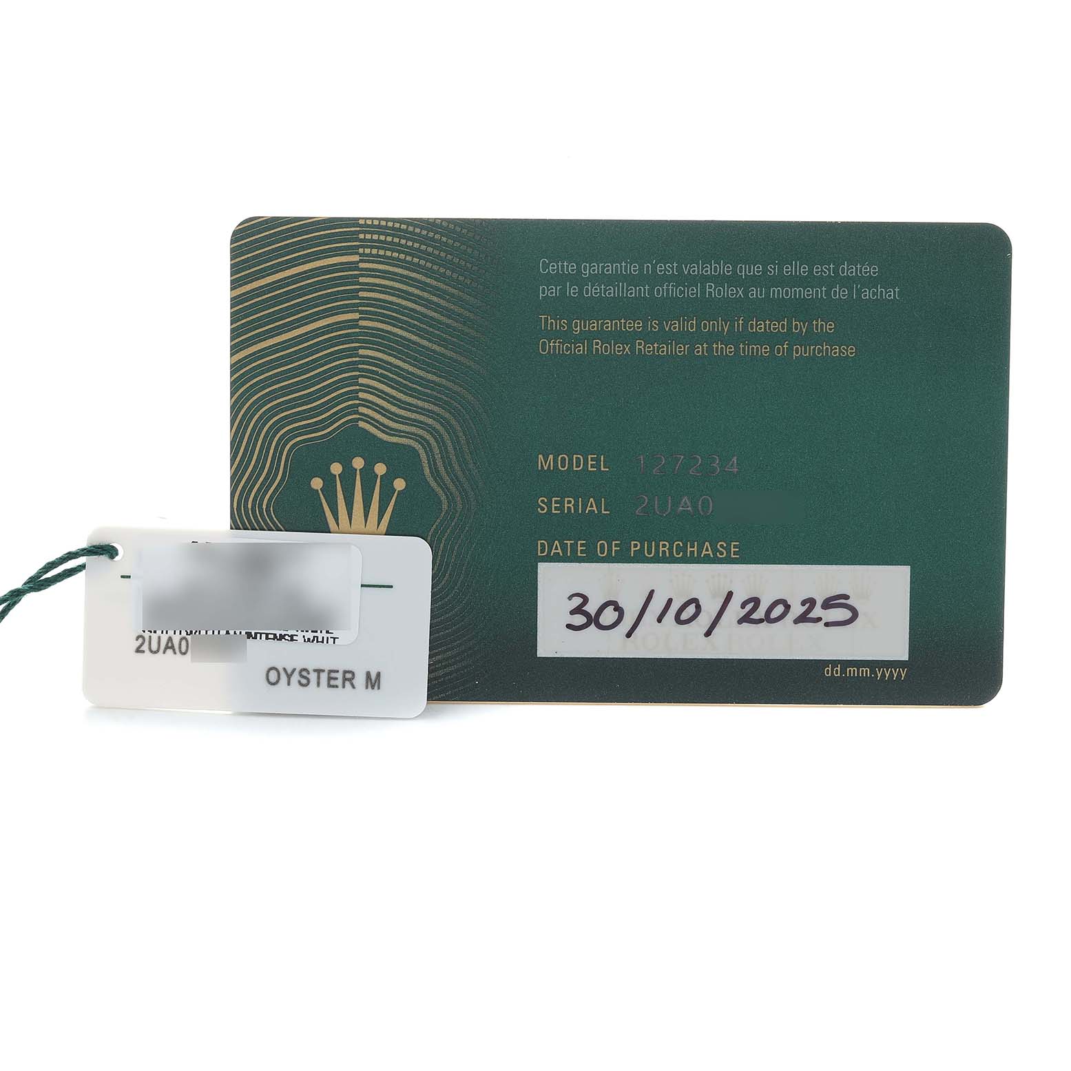 The image shows a warranty card and tag for the Rolex Land-Dweller, displaying model, serial number, and purchase date.